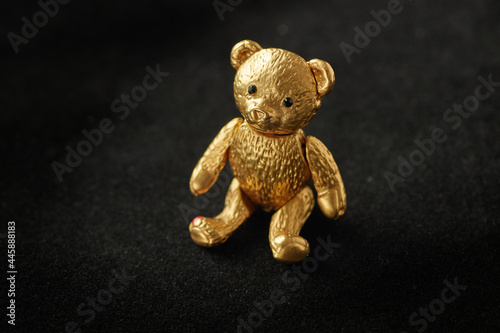 A bear-shaped vintage gold brooch with black gems.