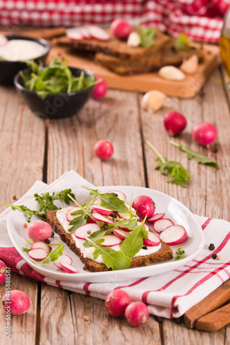 Rye bread with cottage cheese, radish and arugula.