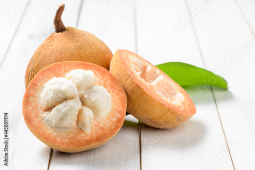 Half Santol on wood background, Santol has sour taste photo