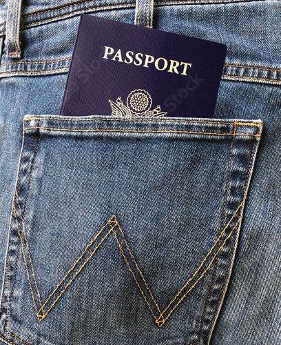 Blue US passport in the man's jeans or denim's rear or back pocket.