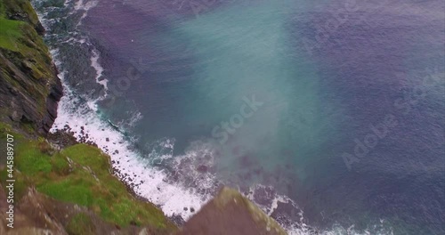 Aerial: Ocean, birds flying and rocky coastline. Cliffs of Moher, Ireland photo