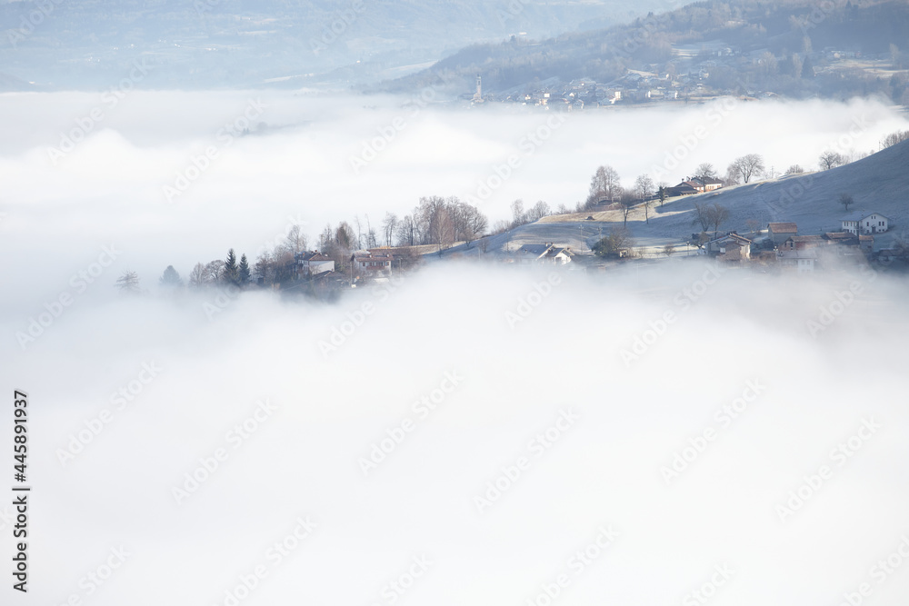 Winter landscape with clouds over town