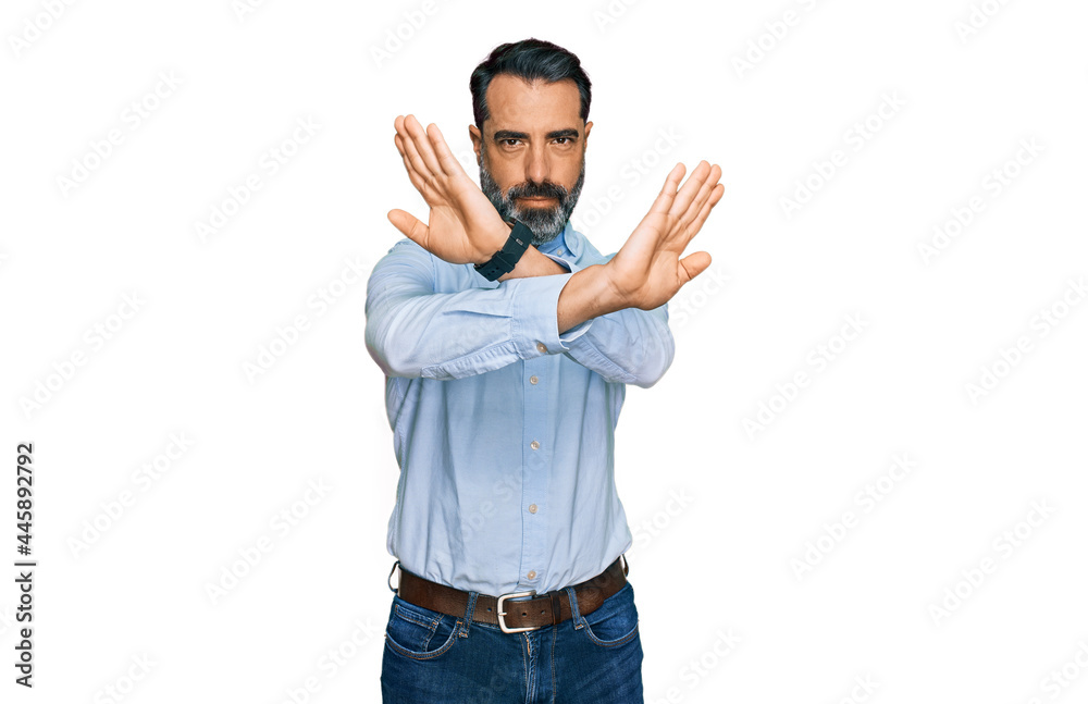 Fototapeta premium Middle aged man with beard wearing business shirt rejection expression crossing arms and palms doing negative sign, angry face