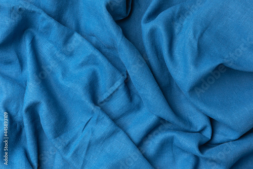 Textured, abstract, background. Cotton textile blue fabric luxurious softness smooth for design backdrop.