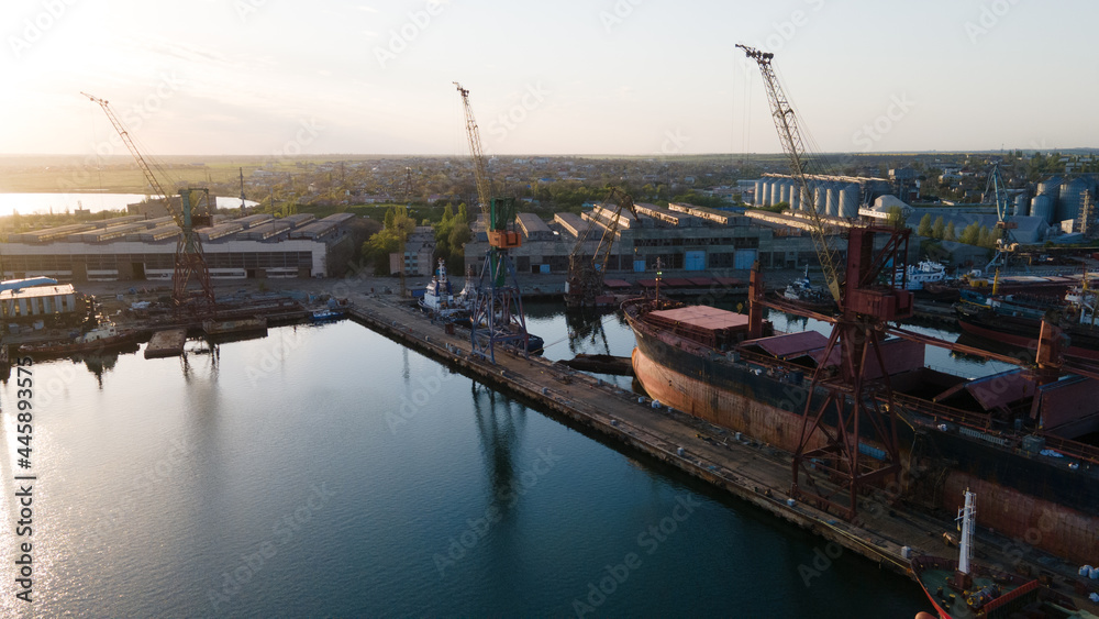 Industrial port in the field of import-export global business logistics and transportation, Loading and unloading container ships, cargo transportation from a bird's eye view.