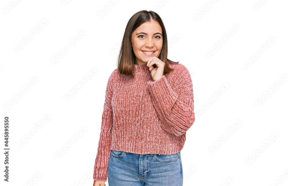 Young beautiful woman wearing casual clothes looking confident at the camera with smile with crossed arms and hand raised on chin. thinking positive. Young beautiful woman wearing casual clothes looking confident at the camera with smile with crossed arms and hand raised on chin. thinking positive.