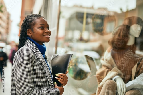 Young african american businesswoman smiling happy standing at the city.