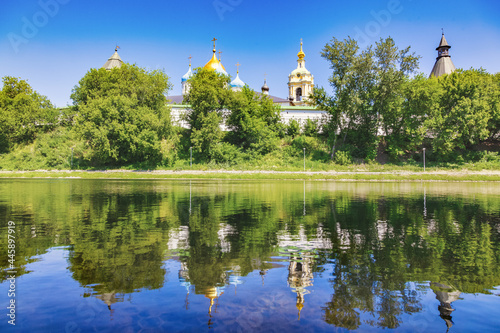 Panoramic view of the Novospassky Stavropol Monastery on a sunny summer day. Reflection of the monastery in the waters of the monastery pond. Moscow, Russia, July 2021
