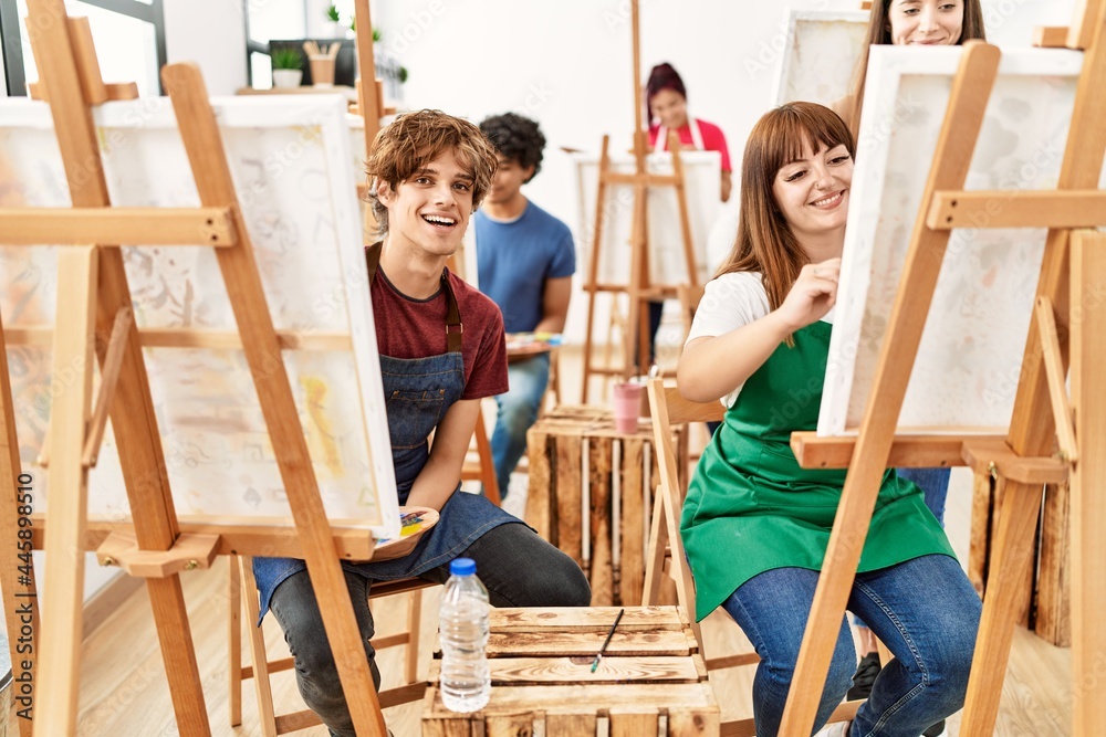 Group of young draw students smiling happy drawing at art studio.