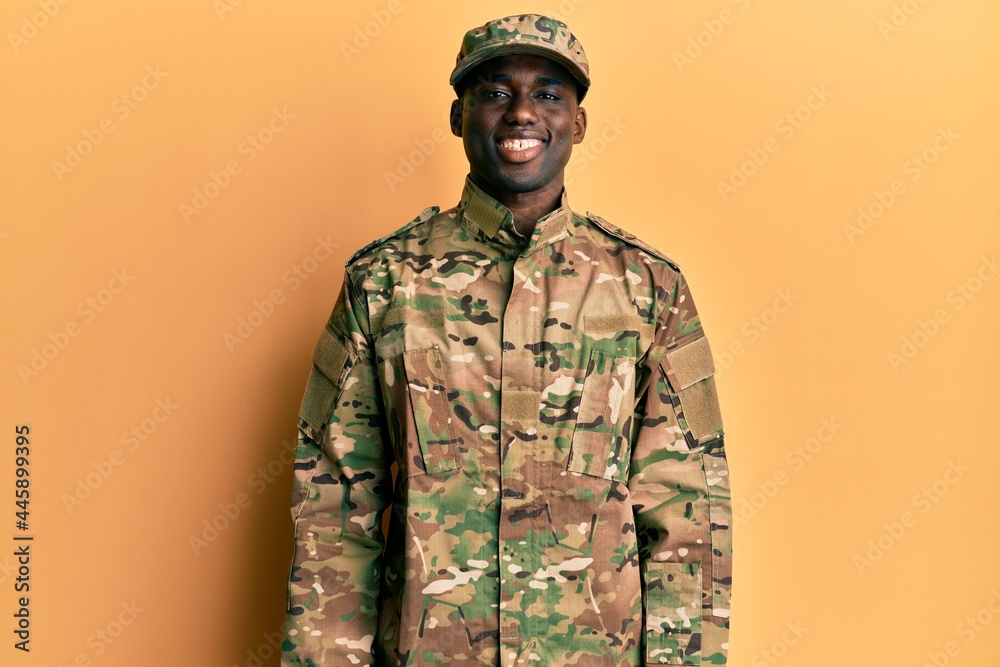 Young african american man wearing army uniform with a happy and cool smile on face. lucky person. Young african american man wearing army uniform with a happy and cool smile on face. lucky person.