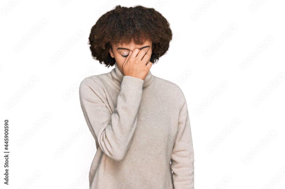 Young hispanic girl wearing wool winter sweater tired rubbing nose and eyes feeling fatigue and headache. stress and frustration concept. Young hispanic girl wearing wool winter sweater tired rubbing nose and eyes feeling fatigue and headache. stress and frustration concept.