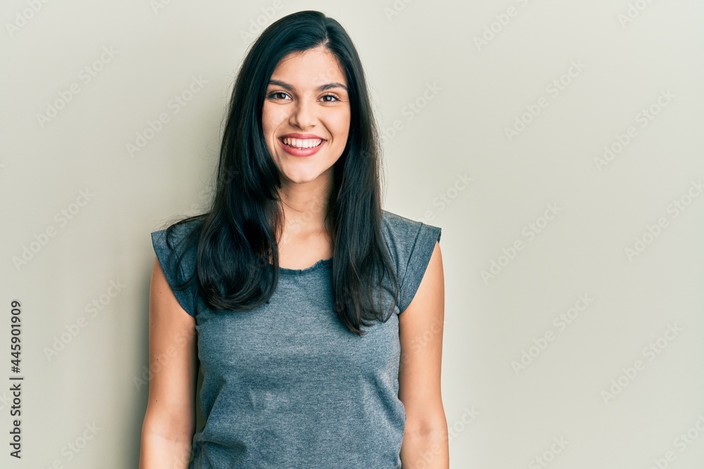 Young hispanic woman wearing casual clothes with a happy and cool smile on face. lucky person. Young hispanic woman wearing casual clothes with a happy and cool smile on face. lucky person.