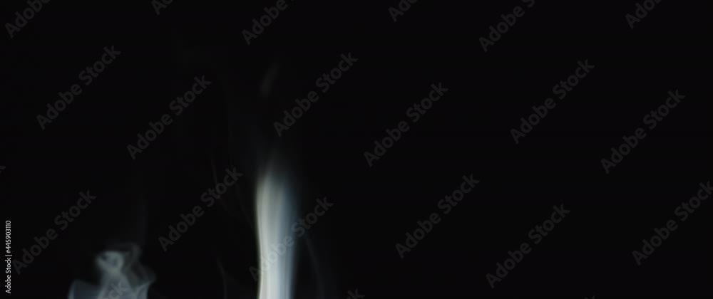 Beautiful incense flames burning in the dark. Abstract background in slow motion. Beautiful incense flames burning in the dark. Abstract background in slow motion.