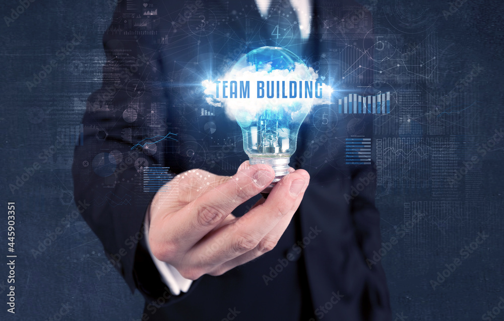 Businessman holding a light bulb, business concept Businessman holding a light bulb, business concept