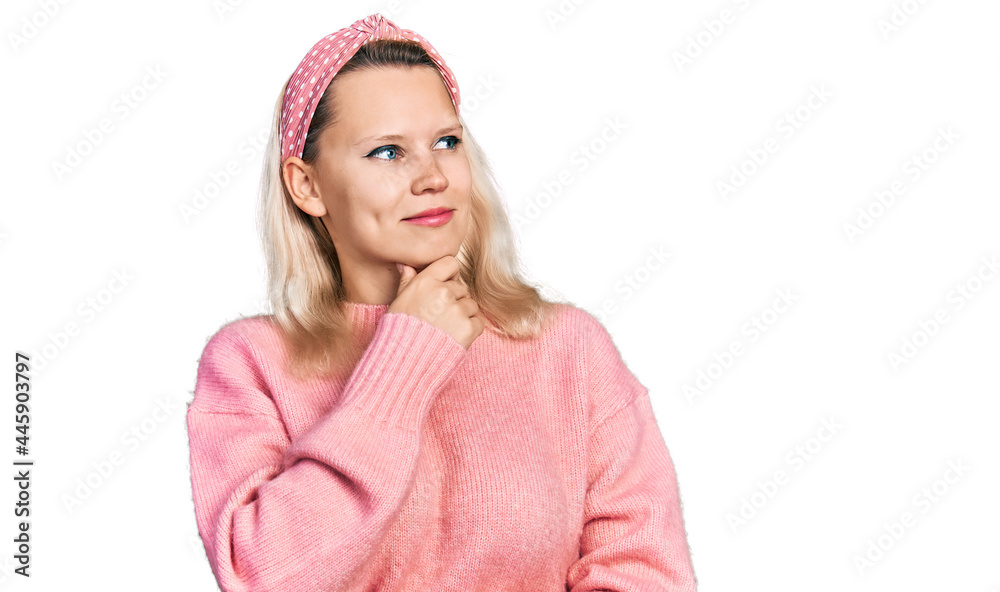 Young caucasian woman wearing casual clothes with hand on chin thinking about question, pensive expression. smiling with thoughtful face. doubt concept.