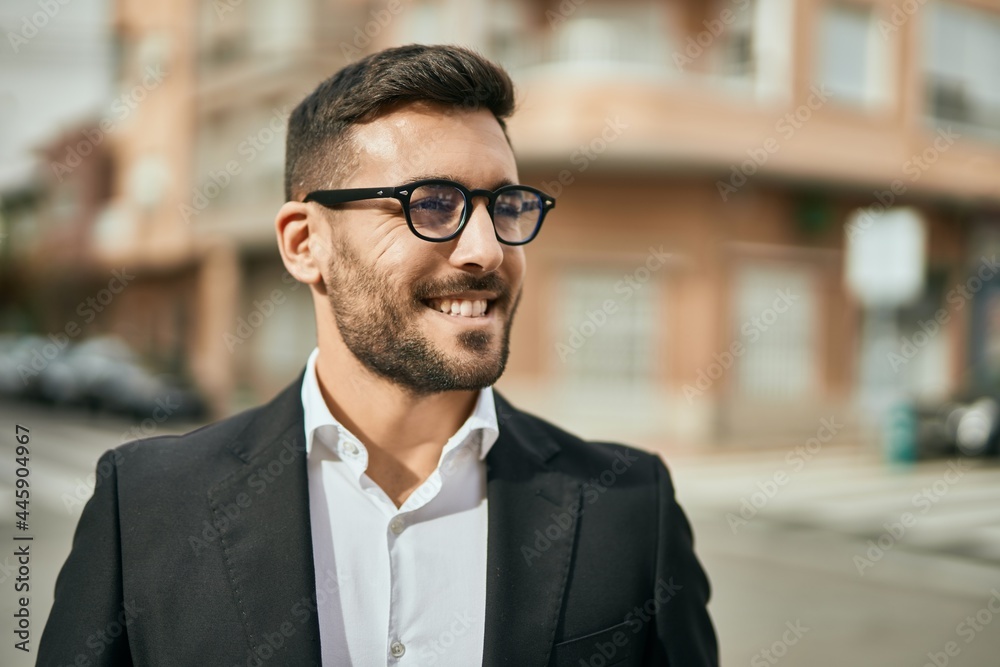 Young hispanic businessman smiling happy standing at the city. Young hispanic businessman smiling happy standing at the city.