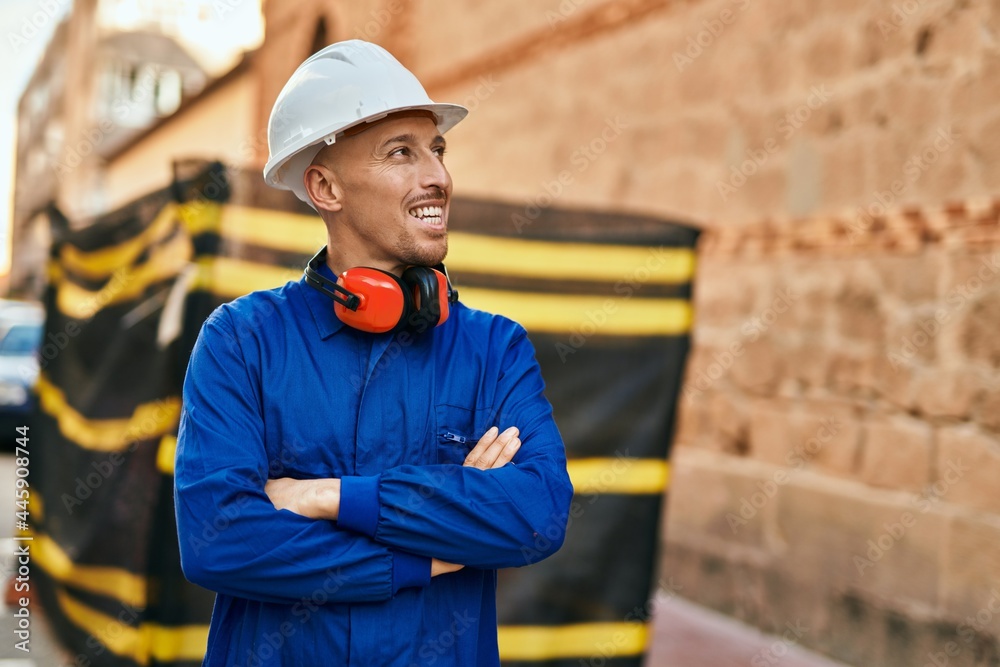 Young caucasian worker smiling happy wearing uniform at the city.