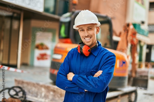 Young caucasian worker smiling happy wearing uniform at the city.