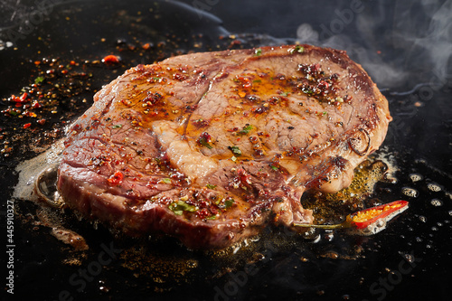 Juicy beef steak cooking in oil