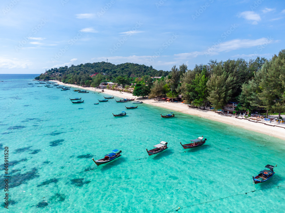 Aerial view of Long tail boats floating on the beautiful transparent sea at Ko Lipe in Thailand, Top view from drone - obrazy, fototapety, plakaty 