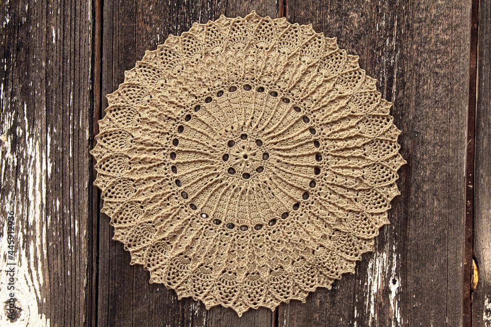 Beautiful closeup crochet doily on old wooden background - obrazy, fototapety, plakaty 