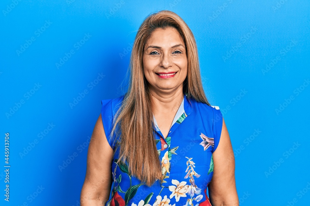 Middle age hispanic woman wearing casual clothes looking positive and happy standing and smiling with a confident smile showing teeth Middle age hispanic woman wearing casual clothes looking positive and happy standing and smiling with a confident smile showing teeth