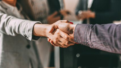 close up. young casual business people shaking hands with each