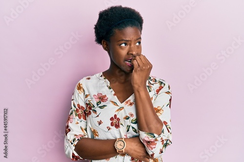Valokuvatapetti Young african american girl wearing casual clothes looking stressed and nervous with hands on mouth biting nails