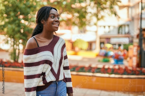 Young african american woman smiling happy standing at the park.