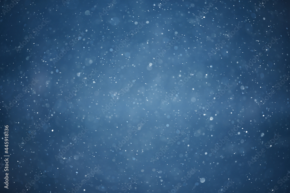 Fototapeta premium blue snowfall bokeh background, abstract snowflake background on blurred abstract blue
