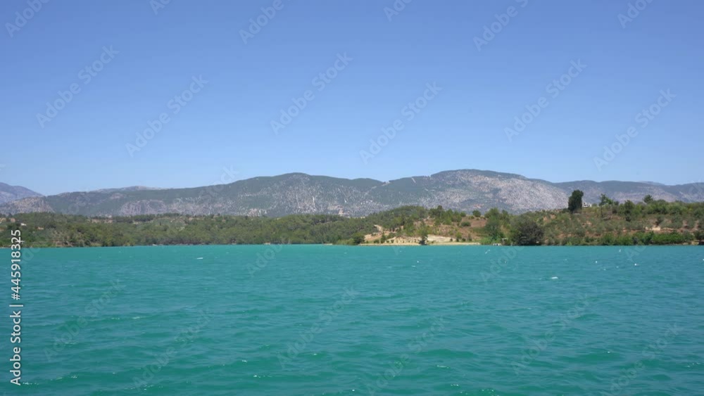 View of the highlands from the ship. Turquoise water of the Green Canyon surrounded by mountains and forest.