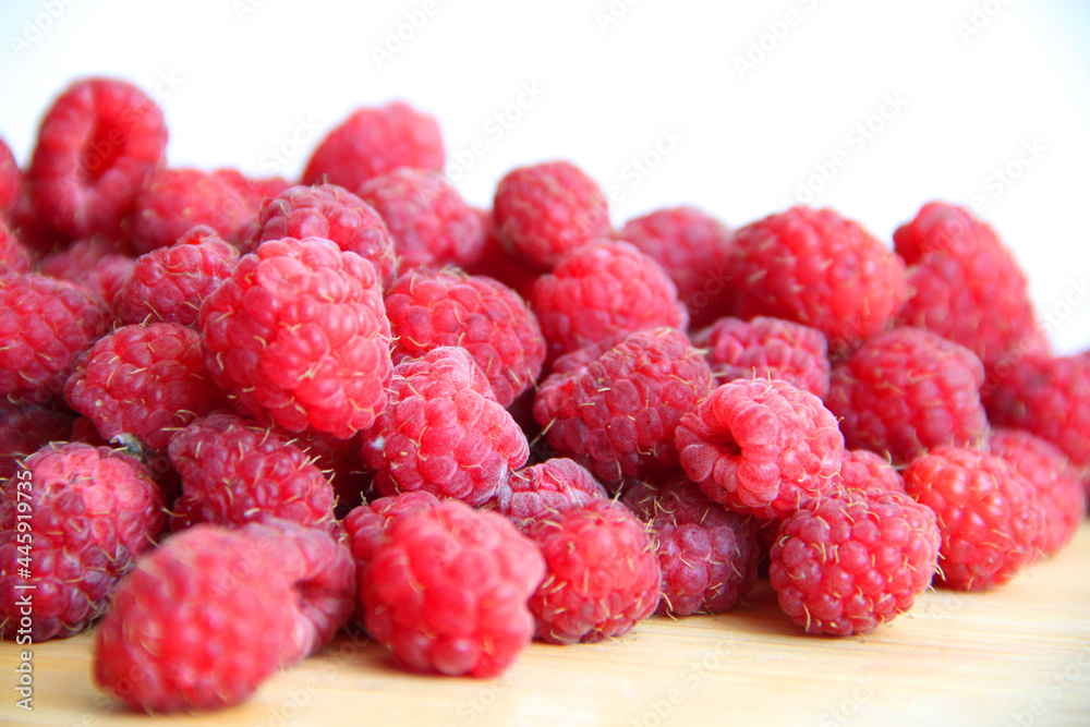 fresh raspberries on a white background close-up fresh raspberries on a white background close-up