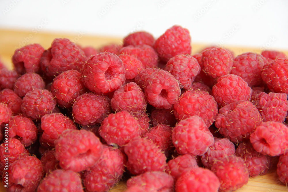 fresh raspberries on a white background close-up fresh raspberries on a white background close-up