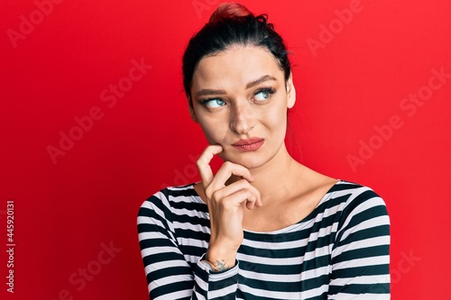Young caucasian woman wearing casual clothes thinking concentrated about doubt with finger on chin and looking up wondering