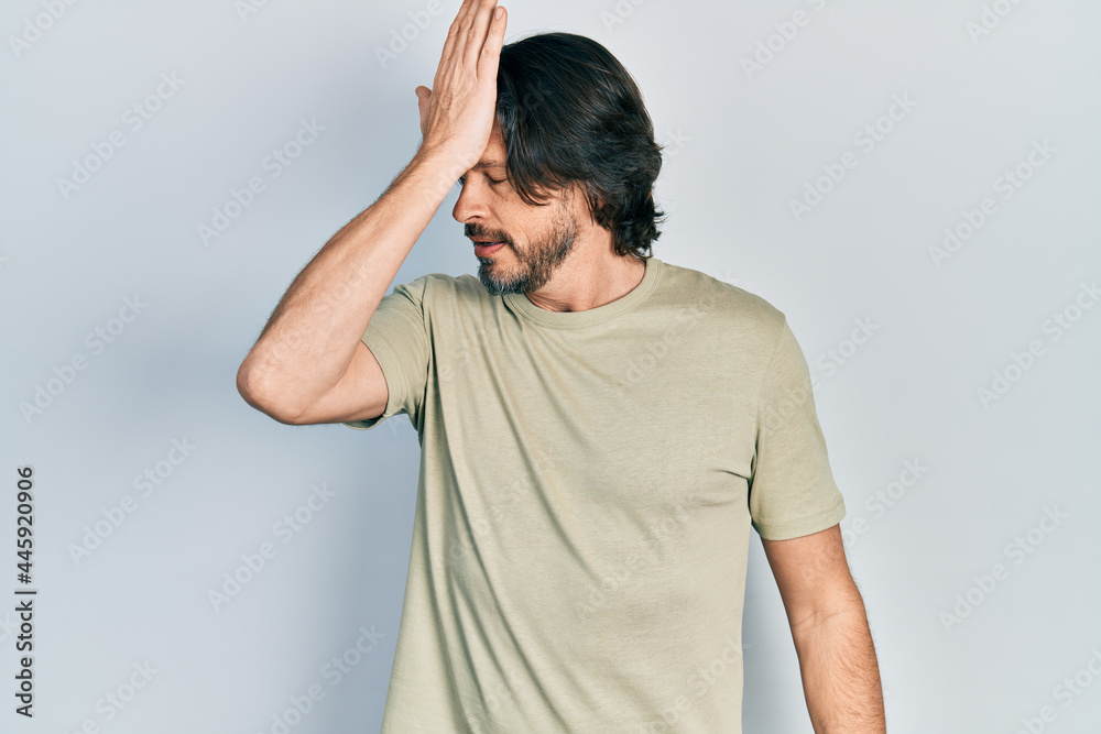 Middle age caucasian man wearing casual clothes surprised with hand on head for mistake, remember error. forgot, bad memory concept.