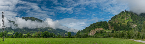 Hills and valley near Sankt Johann im Pongau with fog and green meadows photo