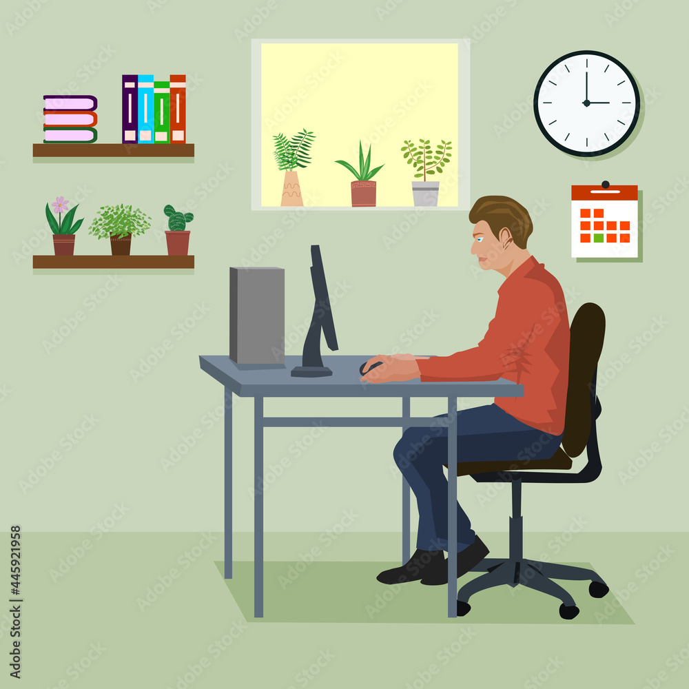 Young man working on the computer programmer . In the room there is a clock, books, flower pots and windows as a background.