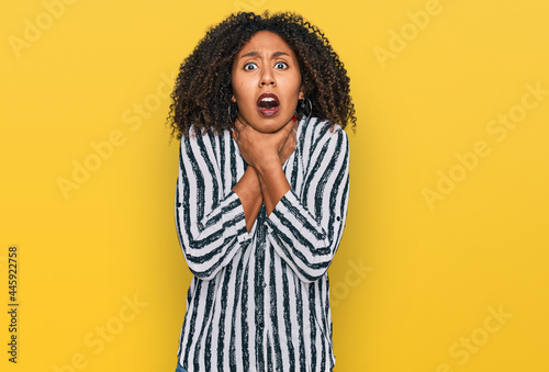 Young african american girl wearing casual clothes shouting and suffocate because painful strangle. health problem. asphyxiate and suicide concept.