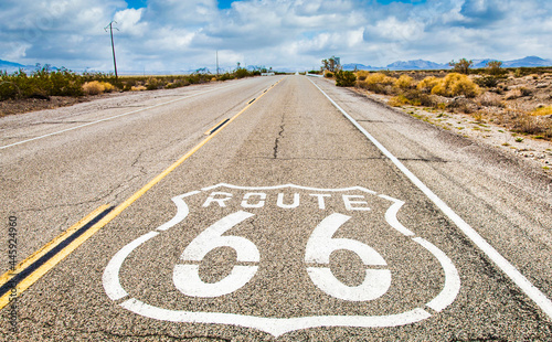 Route 66 road sign with blue sky background. Classic concept for travel and adventure in a vintage way.