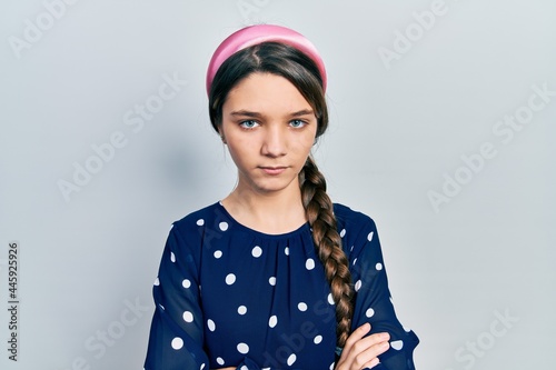 Young brunette girl wearing elegant look skeptic and nervous, disapproving expression on face with crossed arms. negative person.