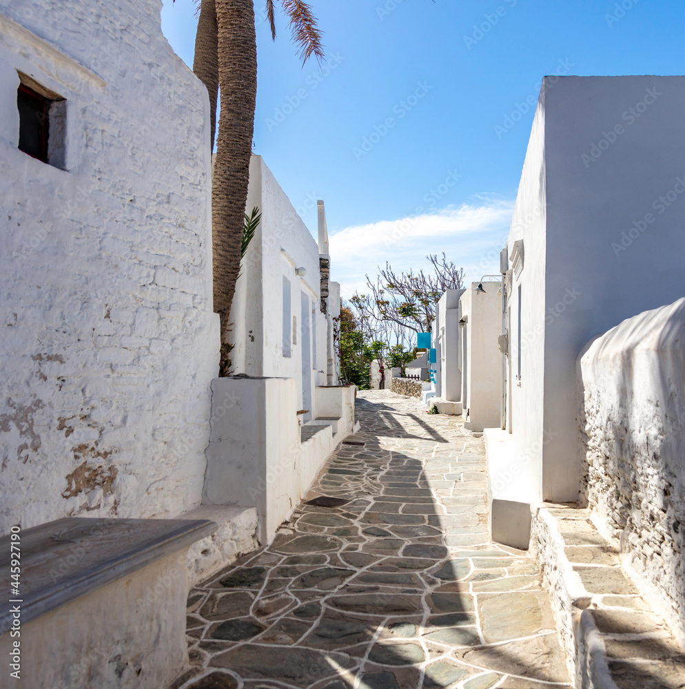 Sifnos island, Kastro village, Cyclades Greece. Whitewashed buildings empty narrow alley background.
