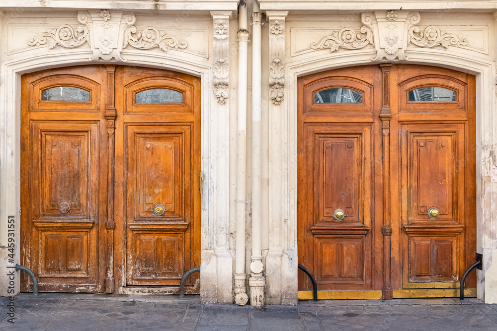 Paris, two ancient wooden doors, typical buildings in the 10e arrondissement, rue de Marseille