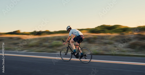 Young man with a bicycle on the road