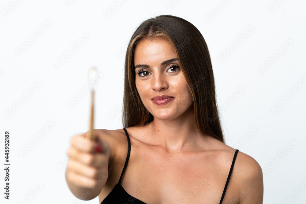 Young Uruguayan woman isolated on white background with a toothbrush Young Uruguayan woman isolated on white background with a toothbrush