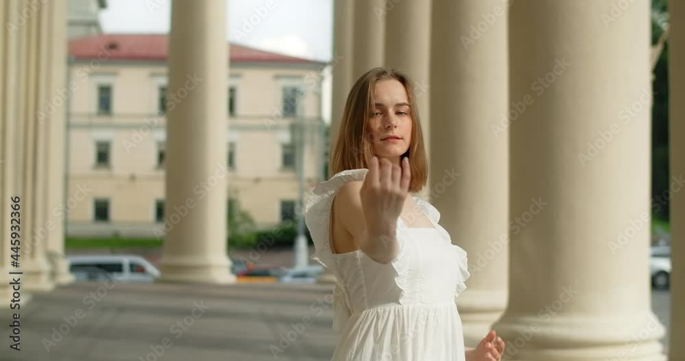 Young dancer woman in white dress whirls in the gallery of columns architectural complex in slow motion, balerina dances outdoors, 4k 120 fps Prores HQ Young dancer woman in white dress whirls in the gallery of columns architectural complex in slow motion, balerina dances outdoors, 4k 120 fps Prores HQ