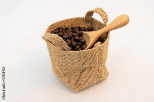 Coffee beans in hemp sack bag isolated on white background.
