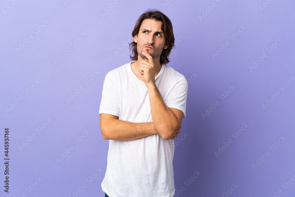 Young handsome man isolated on purple background having doubts and thinking Young handsome man isolated on purple background having doubts and thinking