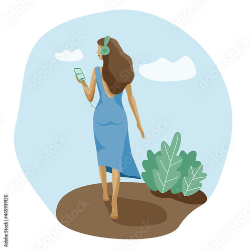 Mental health slim free woman walking with phone listens music audiobook meditation in headphones. Girl flying hair in earphones enjoying sound on eco friendly background of leaves and clouds