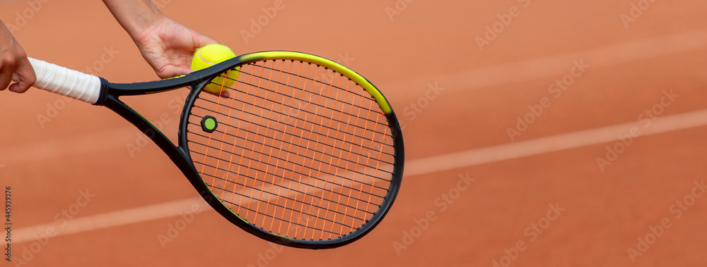 Tennis player prepares to serve a tennis ball during a match. Professional sport concept. Horizontal sport poster, greeting cards, headers, website