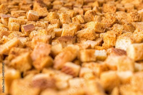 Square-shaped bread crumbs. Oven-fried golden brown bread crumbs. Background.